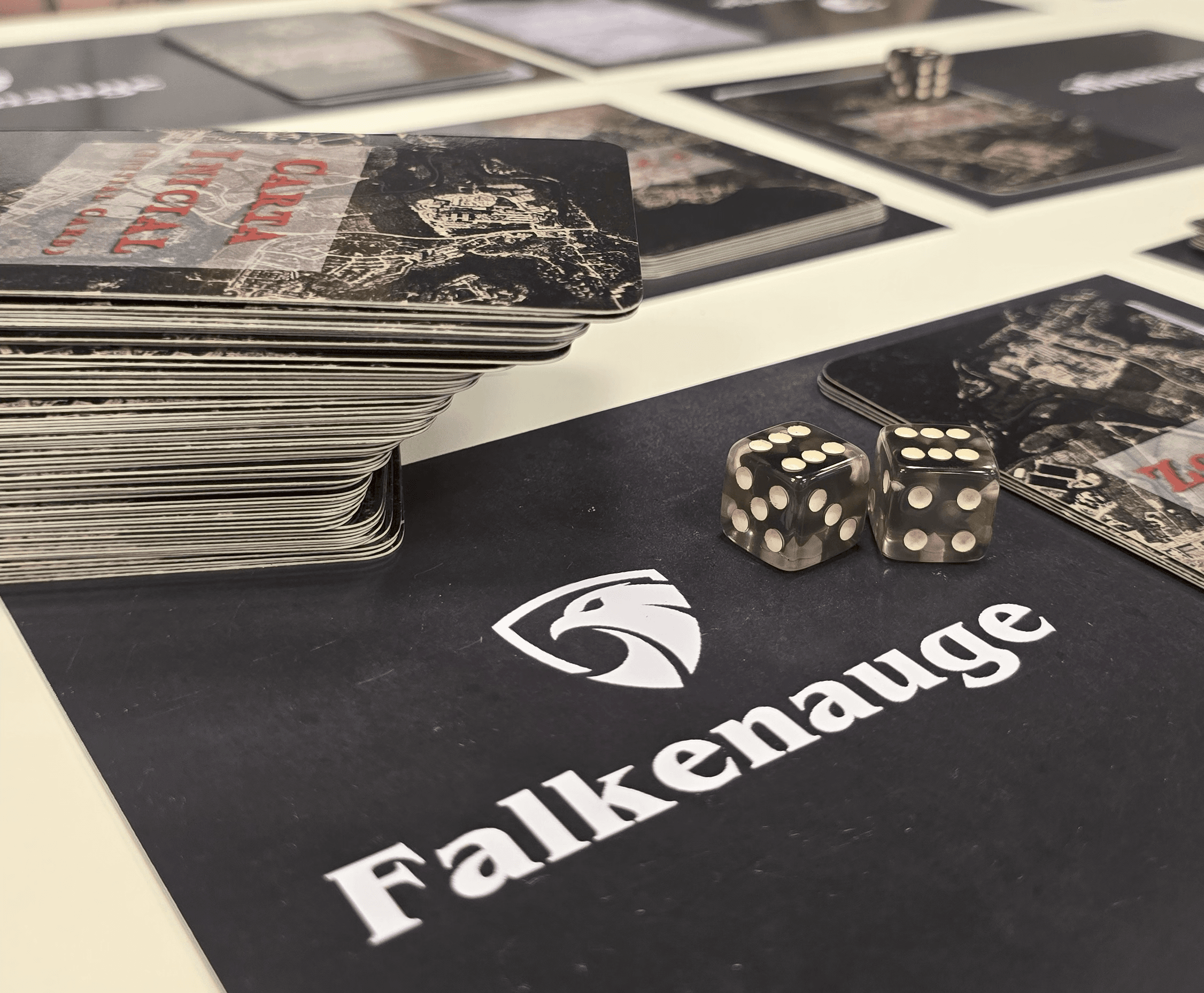 Falcon Eye resource cards and duel dice laid out on the black playing surface, the Falkenauge mark visible.